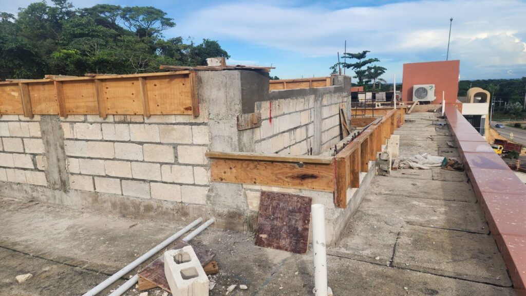 Block walls and timber beam formwork on a rooftop extension