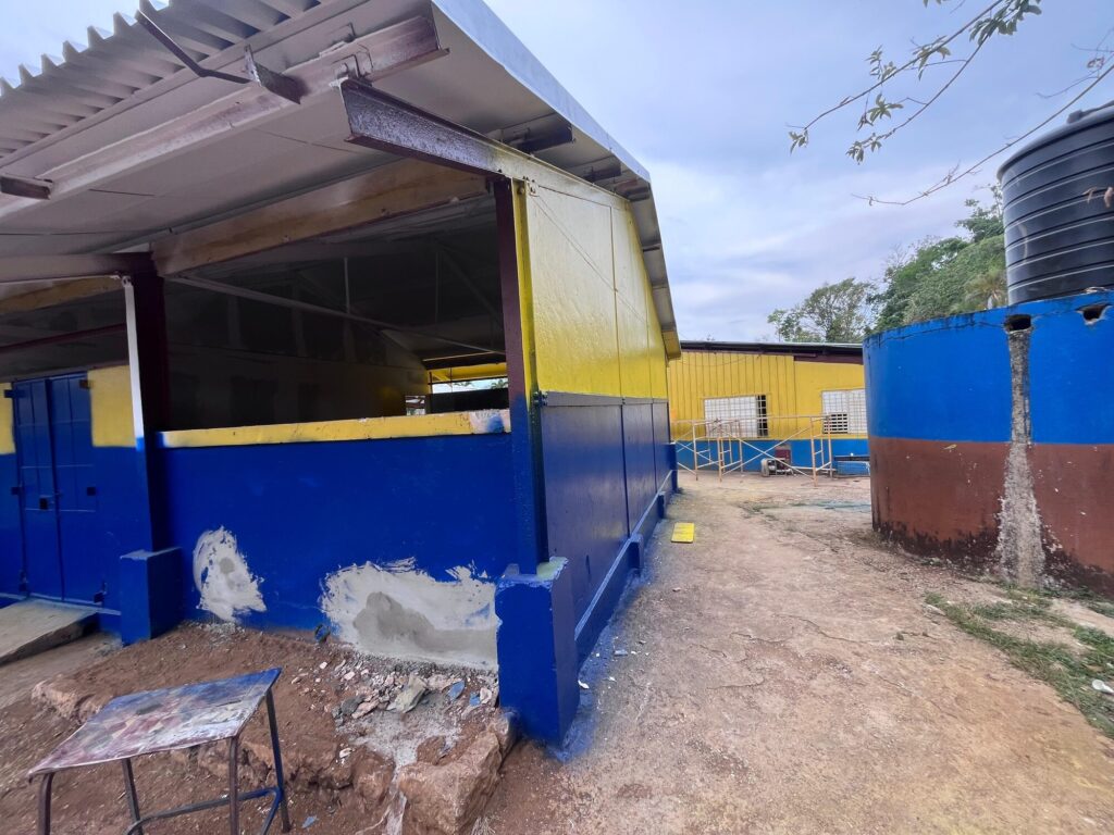 School building renovated and repainted in blue and yellow